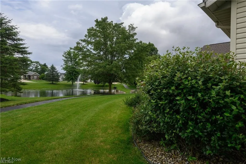 View of grassy yard with a water view