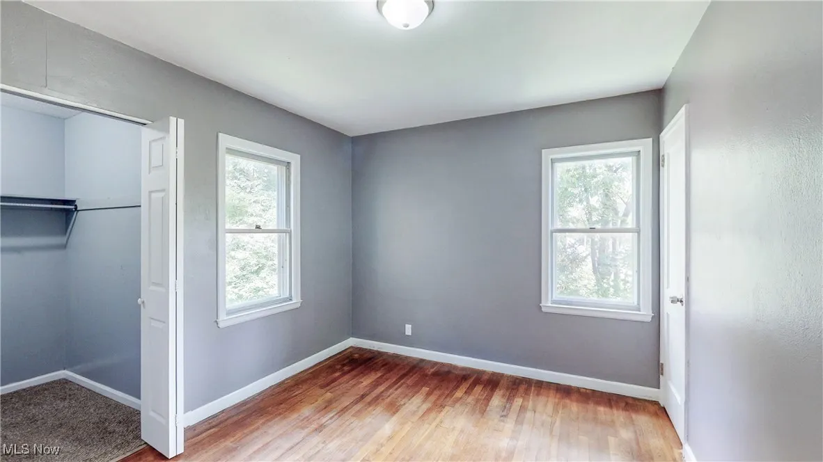 Unfurnished bedroom with a closet and wood finished floors