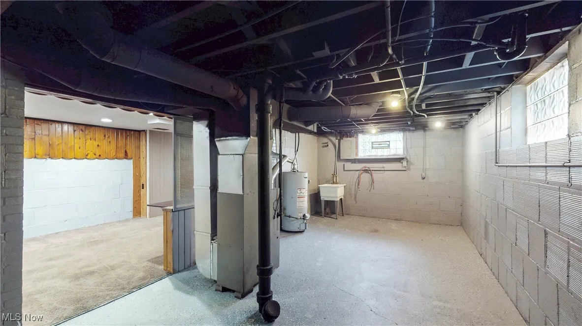 Below grade area with gas water heater and heating unit