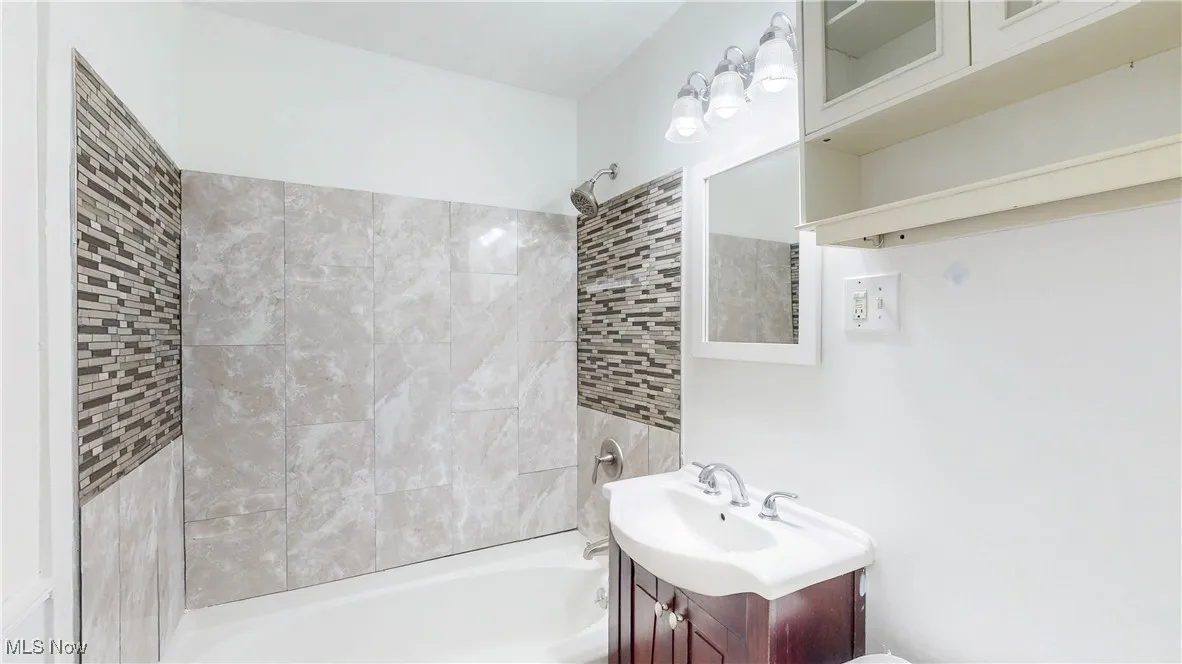 Bathroom featuring vanity and tub / shower combination