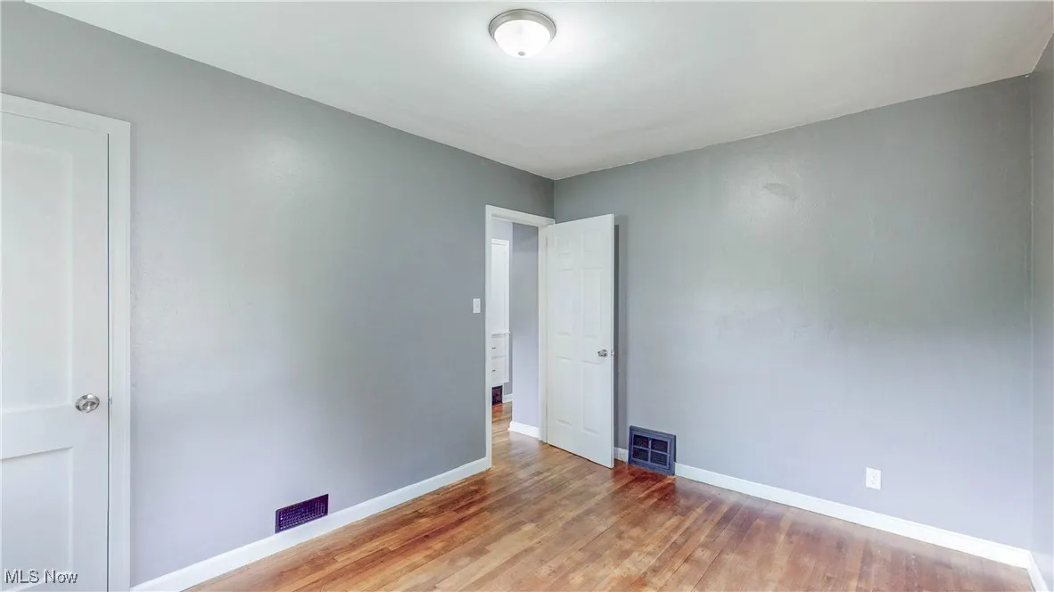 Spare room featuring wood finished floors