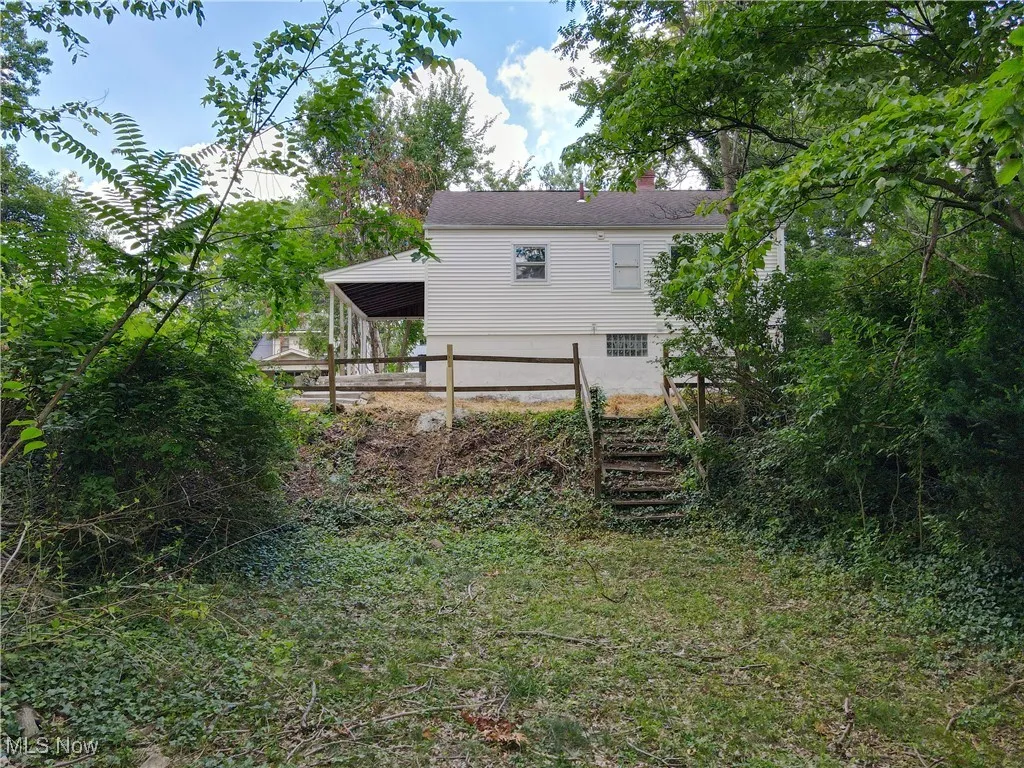 Back of house featuring a chimney