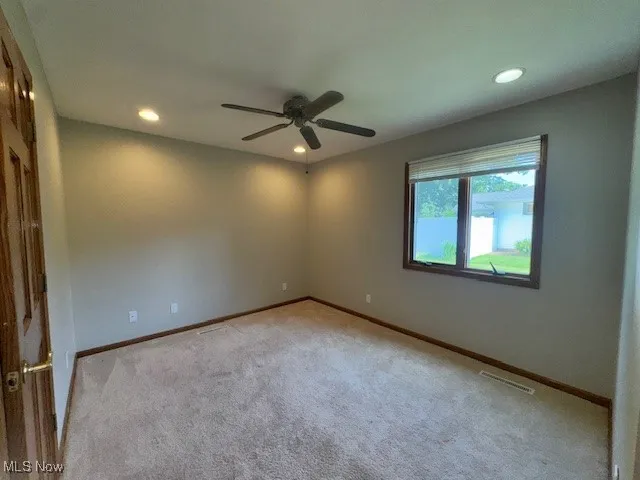 Spare room featuring ceiling fan, recessed lighting, and light colored carpet