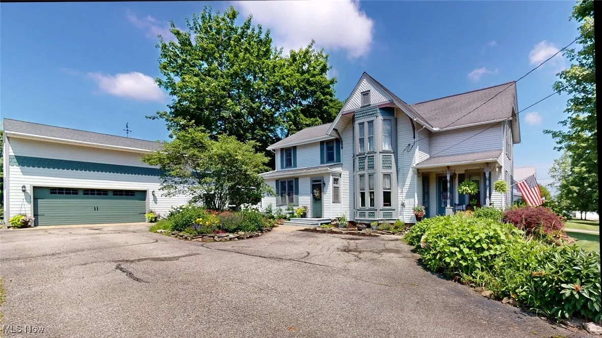Victorian-style house with two car garage and two porches