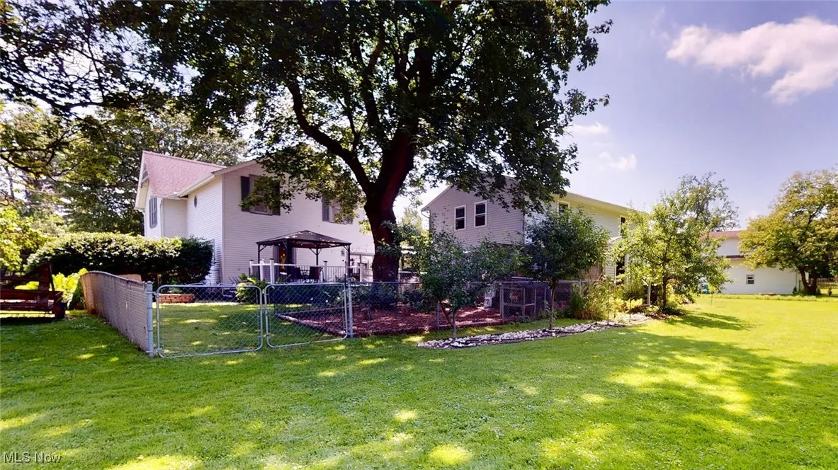 View of yard featuring a gazebo and shady spot to relax