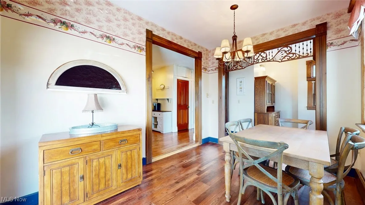 Dining room featuring wood finished floors and a chandelier