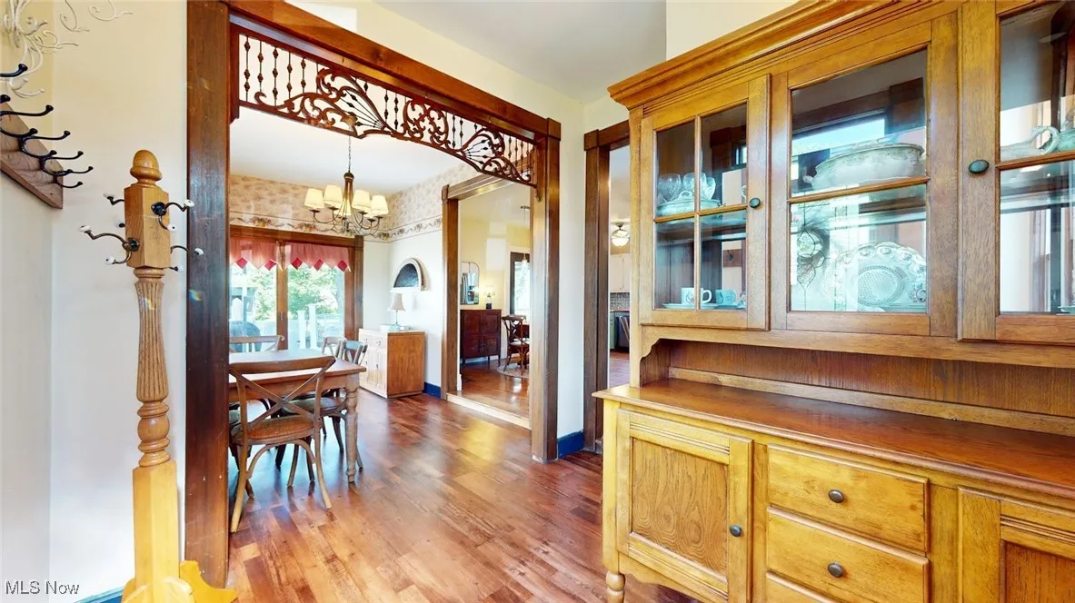 Corridor with a chandelier and wood finished floors