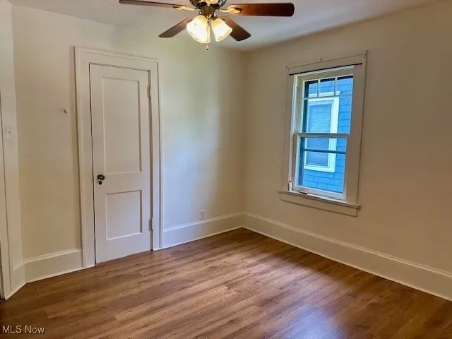 Unfurnished room featuring wood finished floors and ceiling fan
