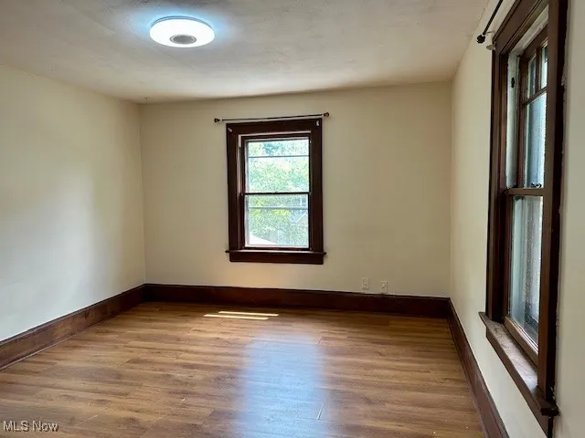 Spare room with wood finished floors and baseboards