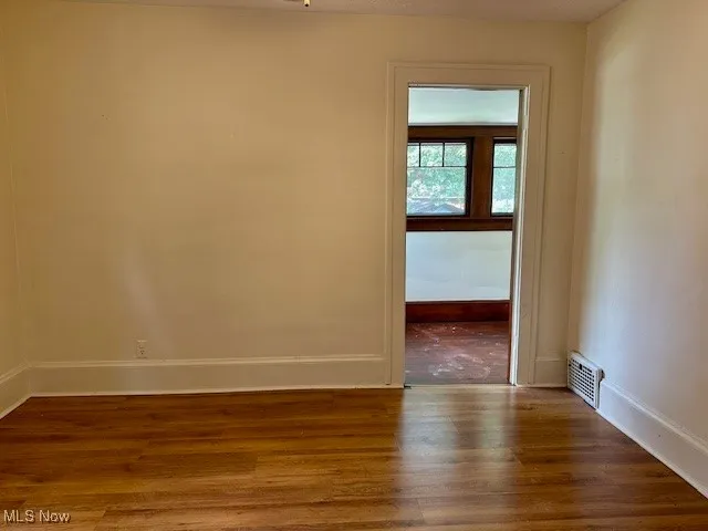 Spare room with wood finished floors and baseboards