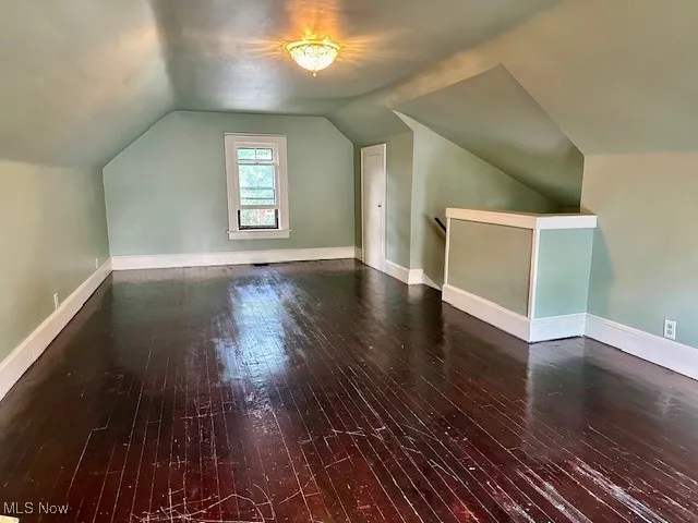 Bonus room featuring hardwood / wood-style flooring and vaulted ceiling