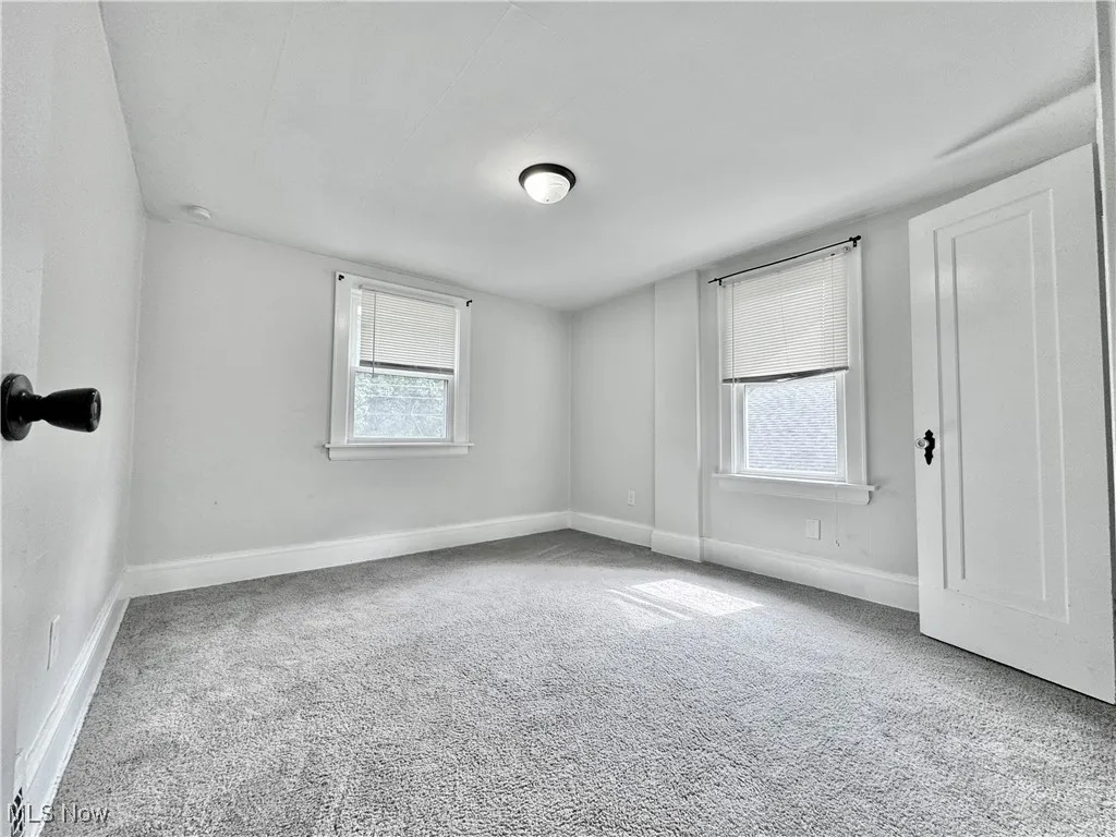 Spare room with carpet floors and baseboards