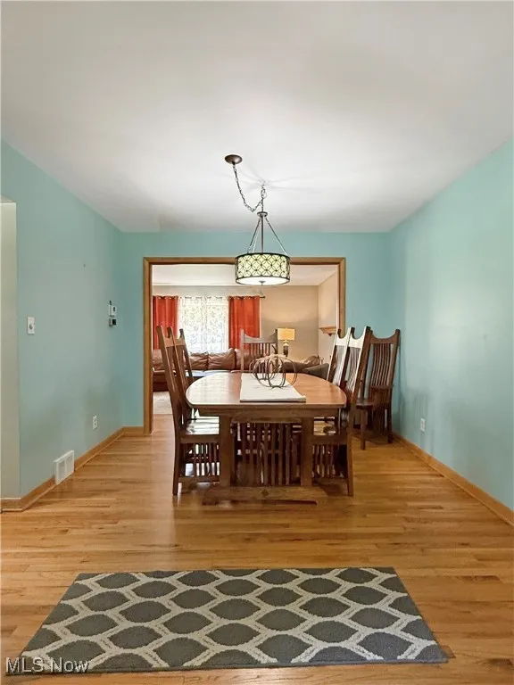 Dining room with light wood finished floors and baseboards