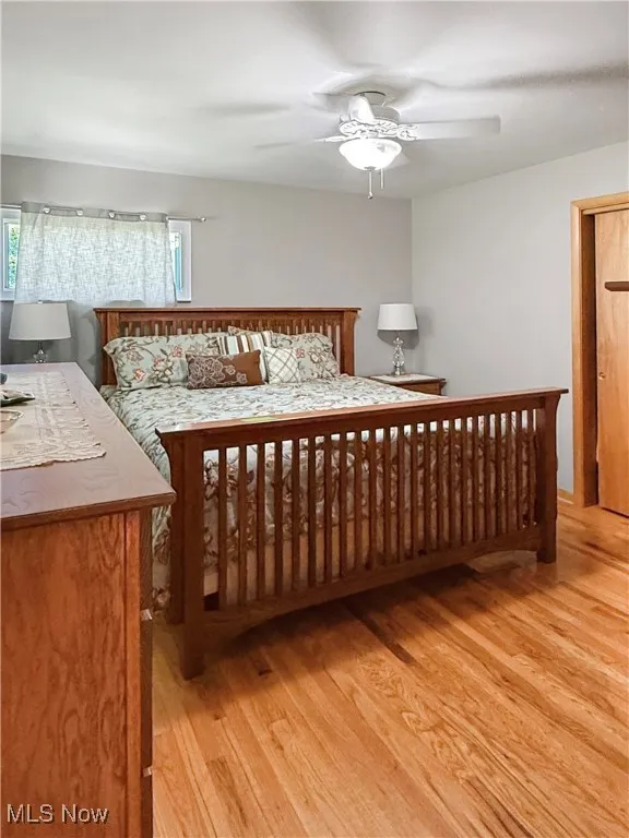 Bedroom with light wood-style flooring and a ceiling fan