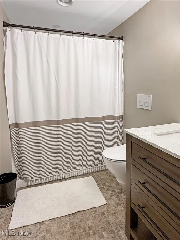 Bathroom featuring vanity and curtained shower