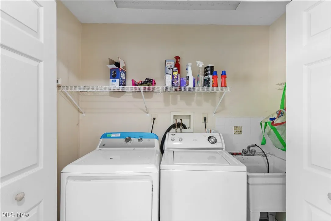 Washroom with washing machine and dryer off the kitchen