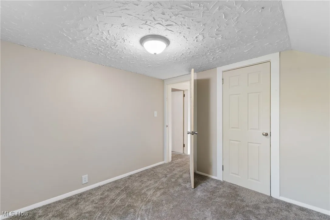Unfurnished bedroom on the 2nd floor featuring carpet floors and a textured ceiling
