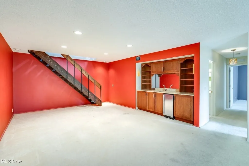 Family room off the living area as well as stairway to loft and hallway to 2nd and 3rd bedrooms and full bath.