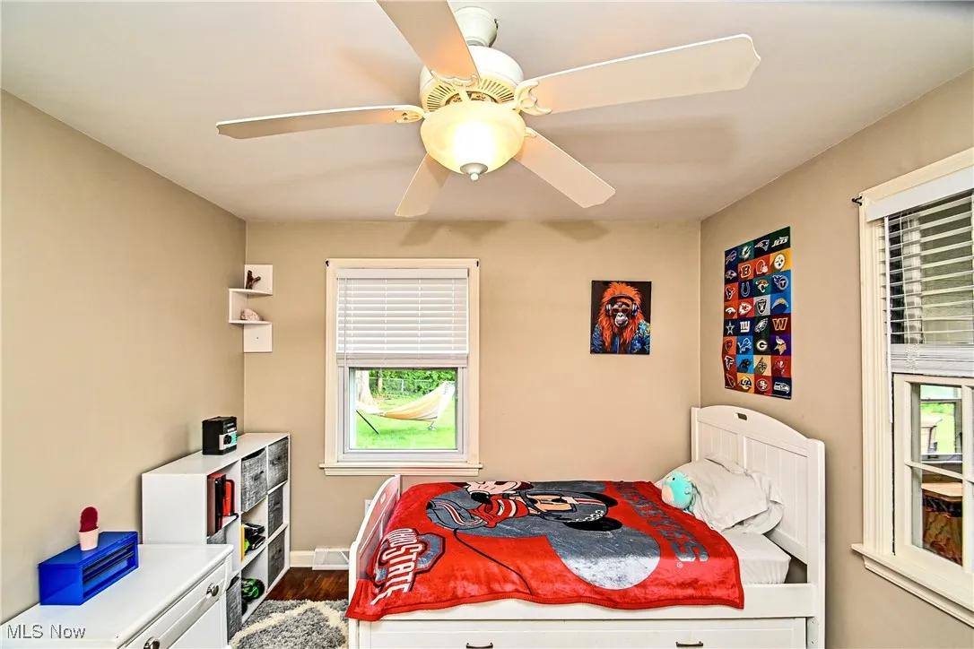 Bedroom featuring dark wood-style floors and ceiling fan