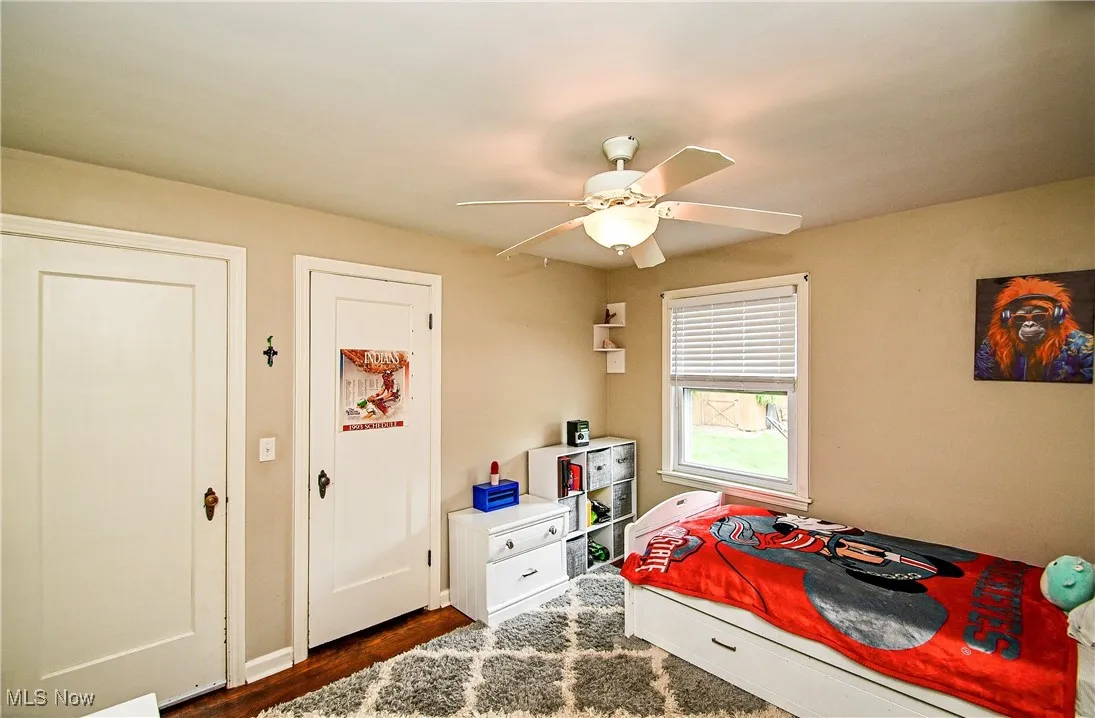 Bedroom featuring dark wood-style floors and a ceiling fan