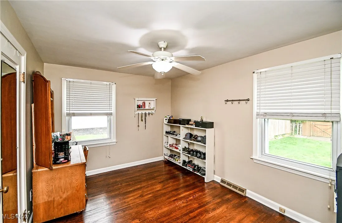 Office with a ceiling fan and wood finished floors