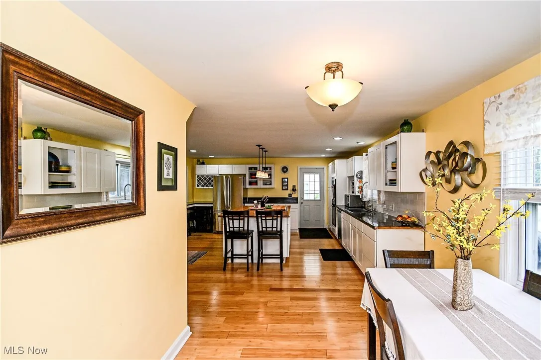 Dining space featuring light wood-type flooring and recessed lighting