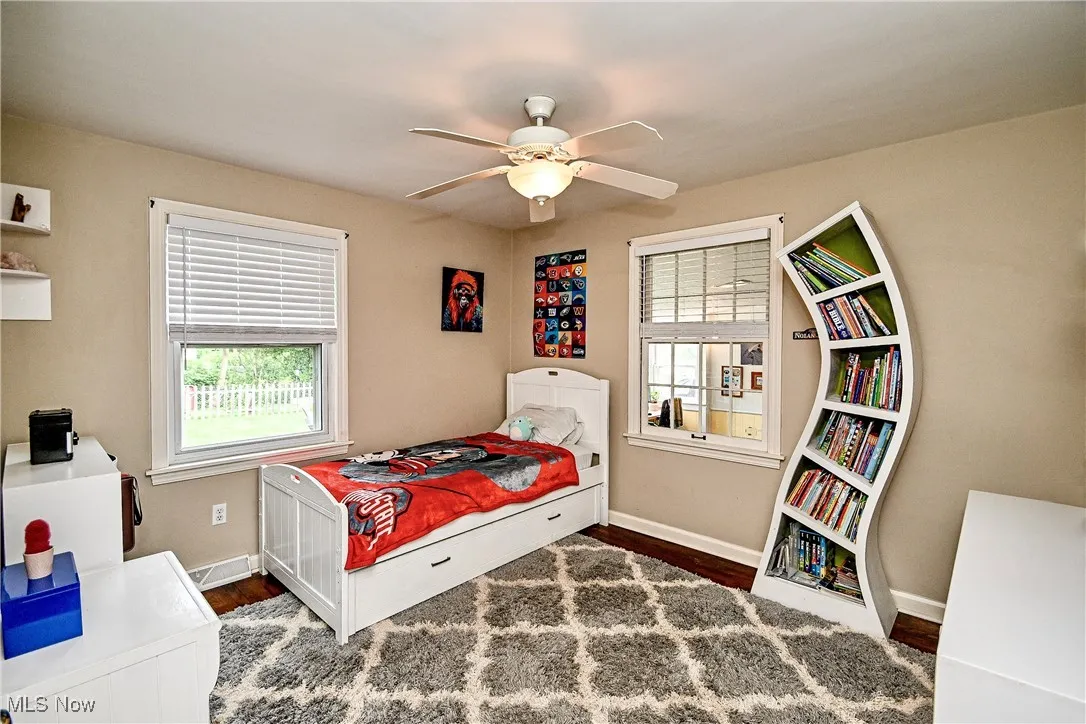 Bedroom with wood finished floors and ceiling fan