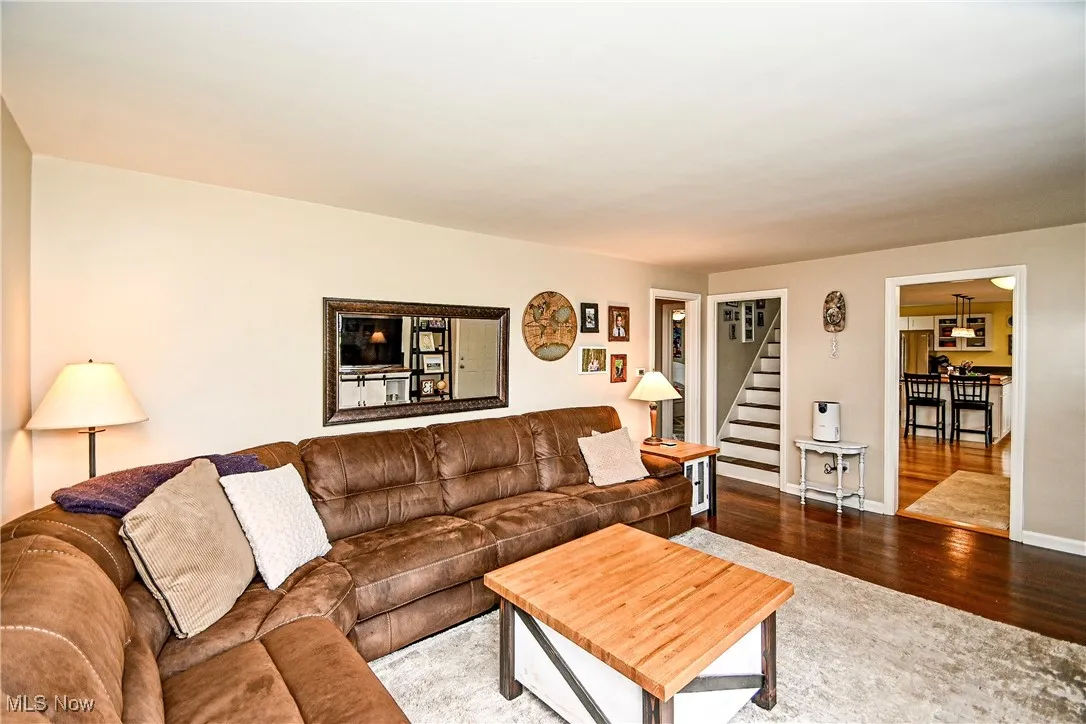 Living area featuring stairs and wood finished floors