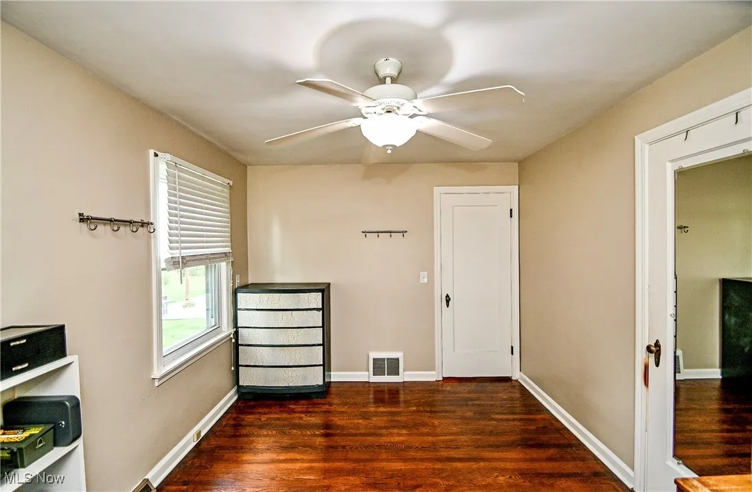 Unfurnished room featuring wood finished floors and a ceiling fan
