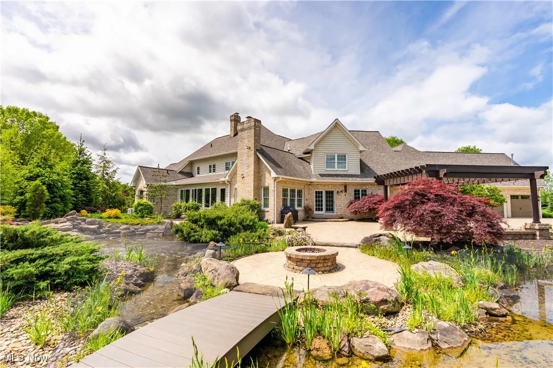 Relax in this rear oasis with pergola, pond and firepit.