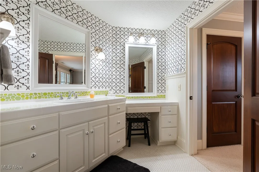 Separate lighted vanity area in this full bath off bedroom 2.