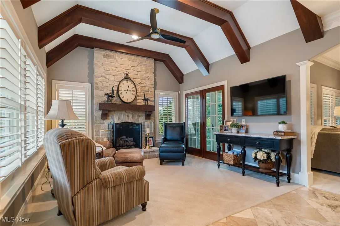 Gorgeous beamed ceiling in this hearth room with another fireplace.