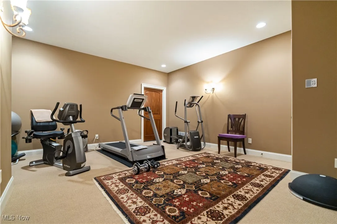 Carpeted flex space for exercise/playroom/craft room.