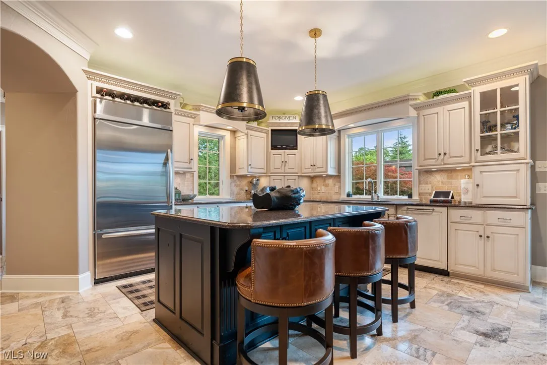 Island area with granite countertop and fantastic lights.