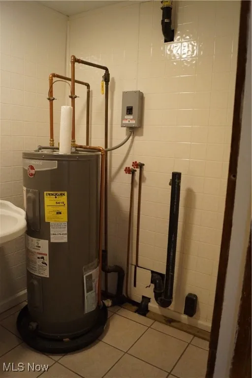 Utility room featuring water heater