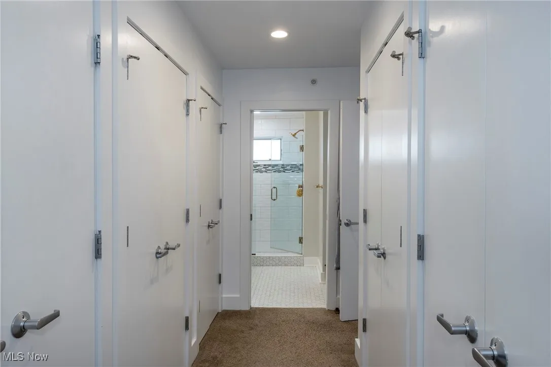 Hall with carpet floors and recessed lighting
