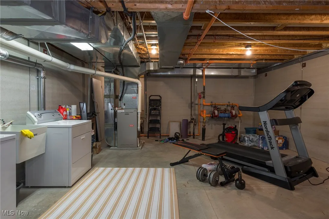 Unfinished basement with heating unit and washer and dryer