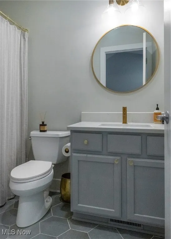 Bathroom featuring vanity, tile patterned floors, and a shower with curtain