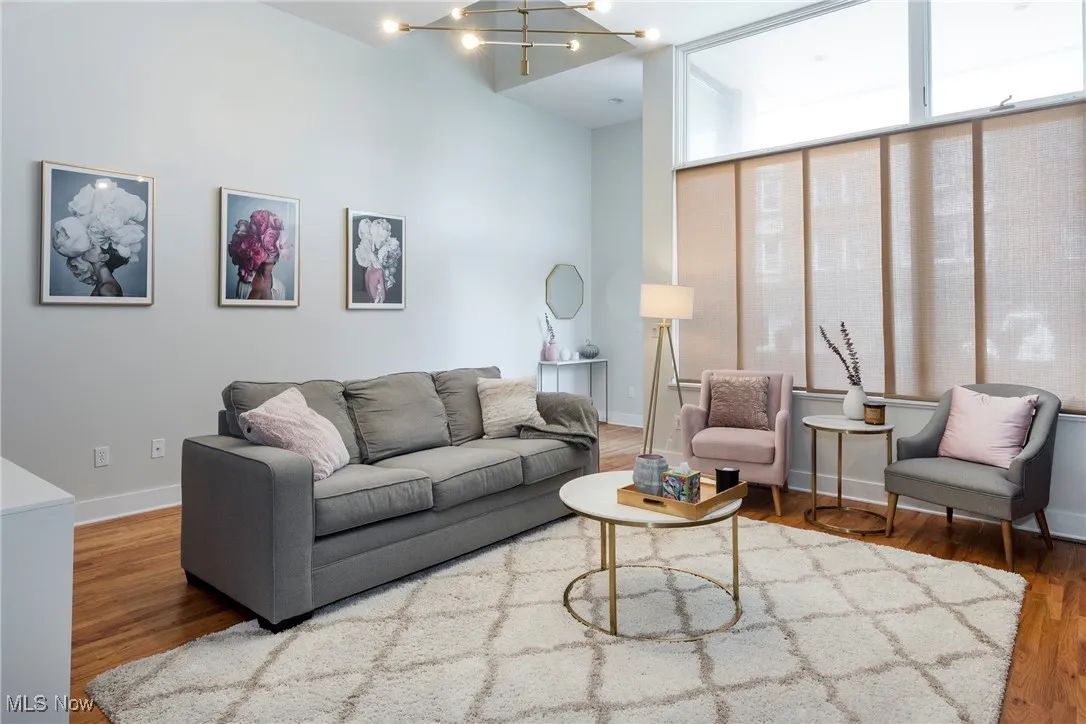 Living area featuring wood finished floors and a chandelier