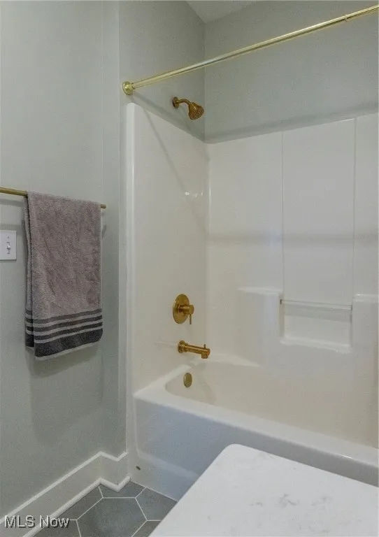 Bathroom with shower / bath combination and tile patterned floors