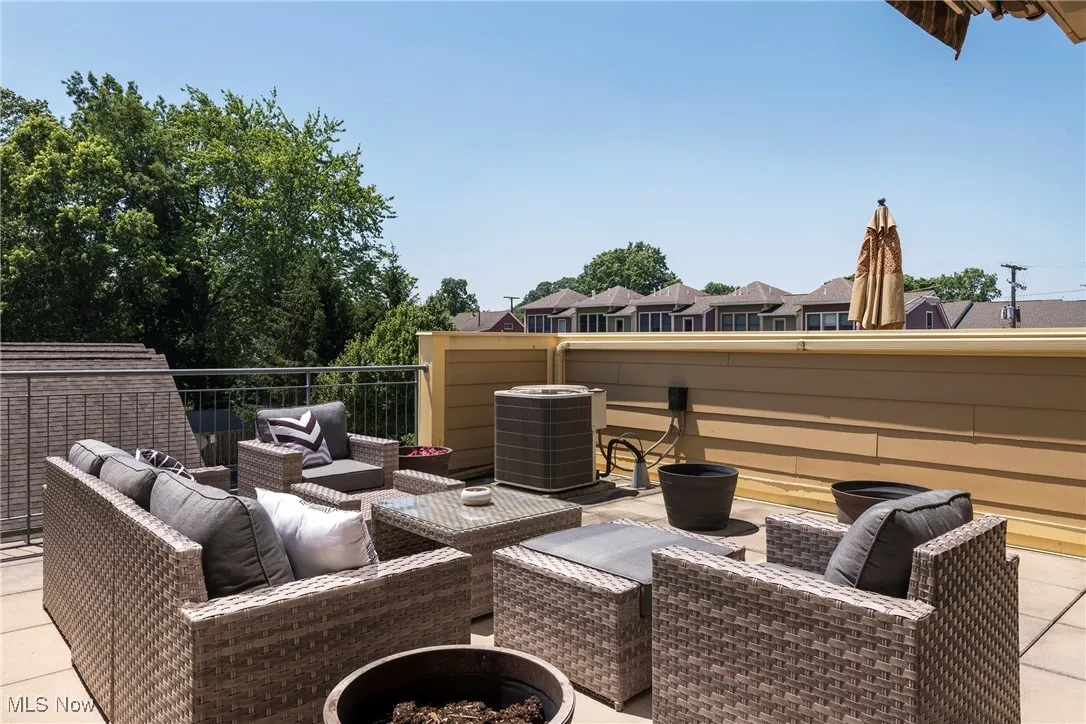 View of patio with an outdoor living space with a fire pit