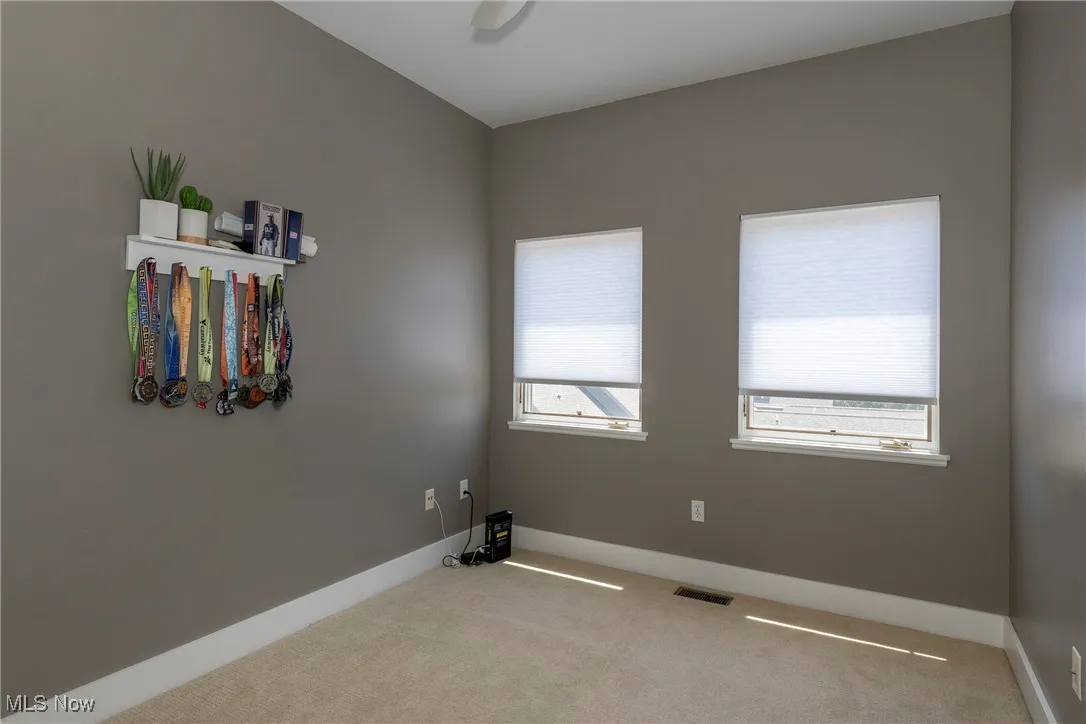 Carpeted spare room with baseboards