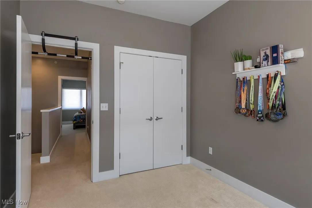 Bedroom featuring light colored carpet and a closet