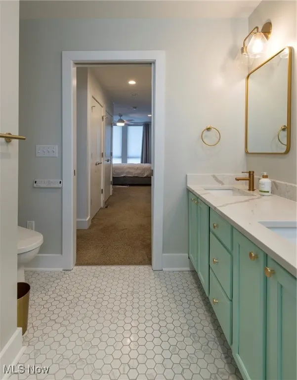 Bathroom with double vanity and a ceiling fan