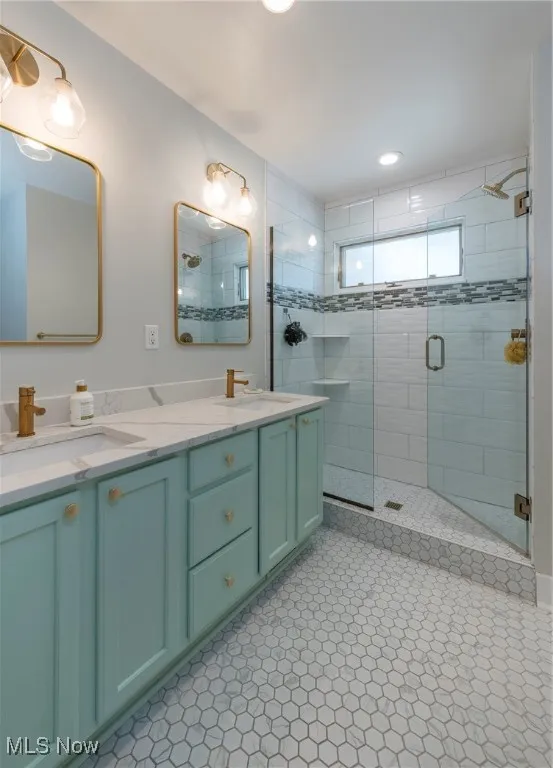 Full bathroom featuring a shower stall and double vanity