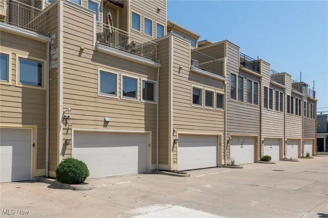 View of building exterior with a garage and driveway