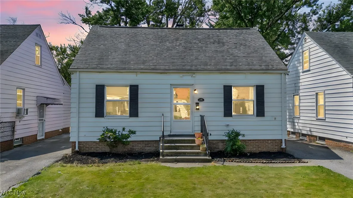 Cape cod-style house with a yard and cooling unit