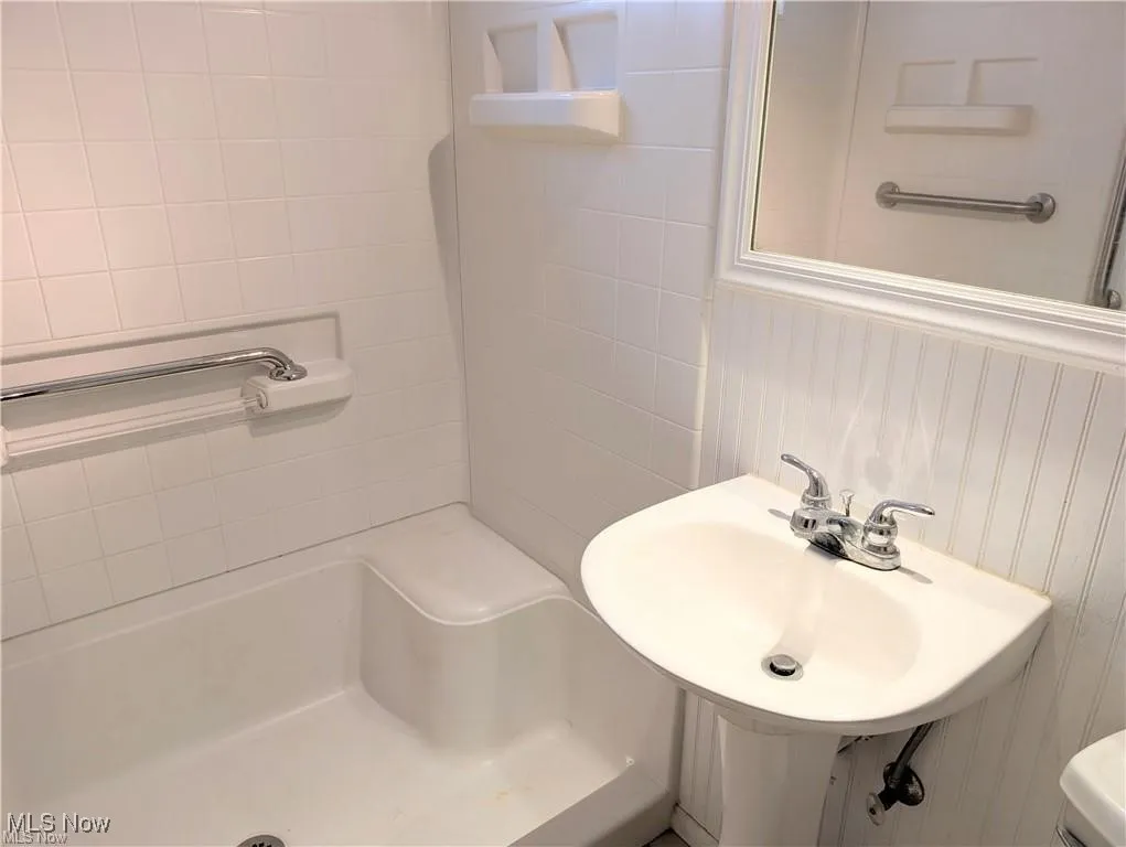 Bathroom with a shower and a bathtub