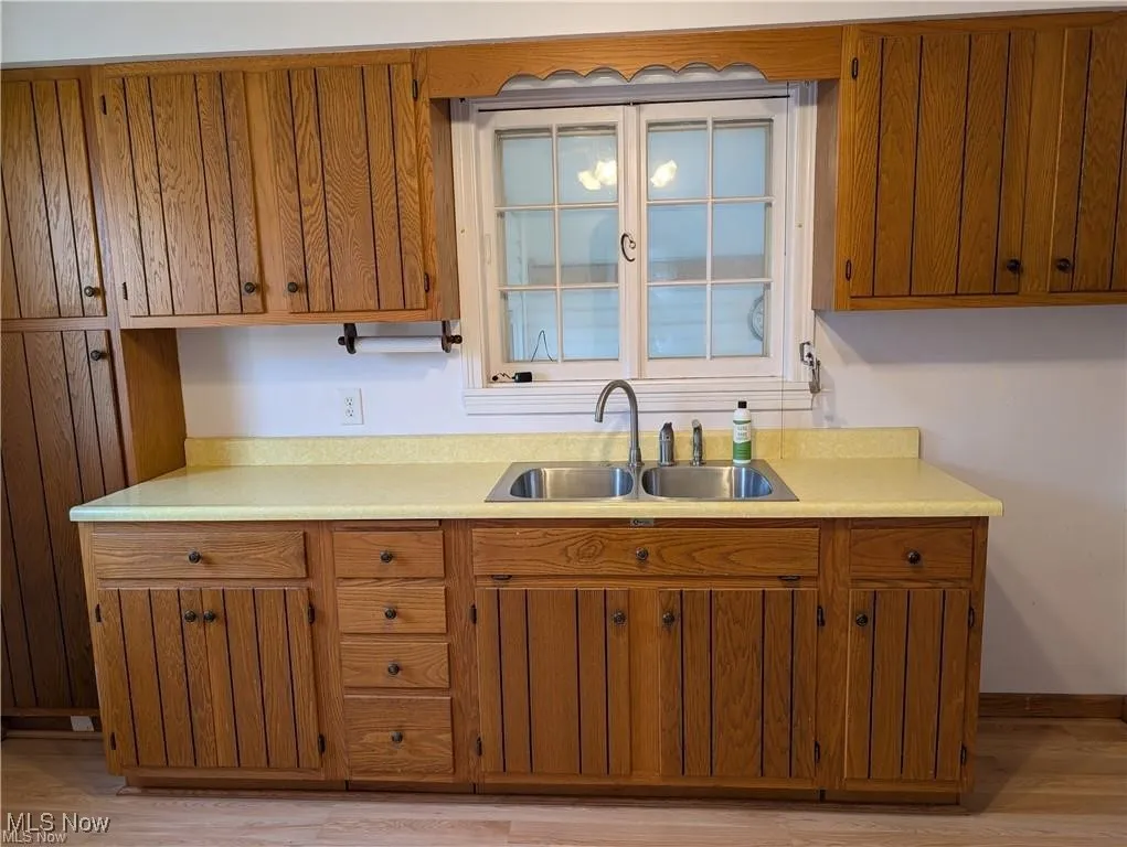 Kitchen featuring brown cabinetry and light countertops