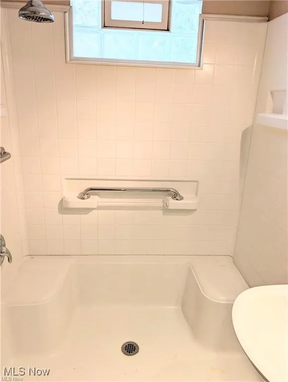 Bathroom with a shower and plenty of natural light